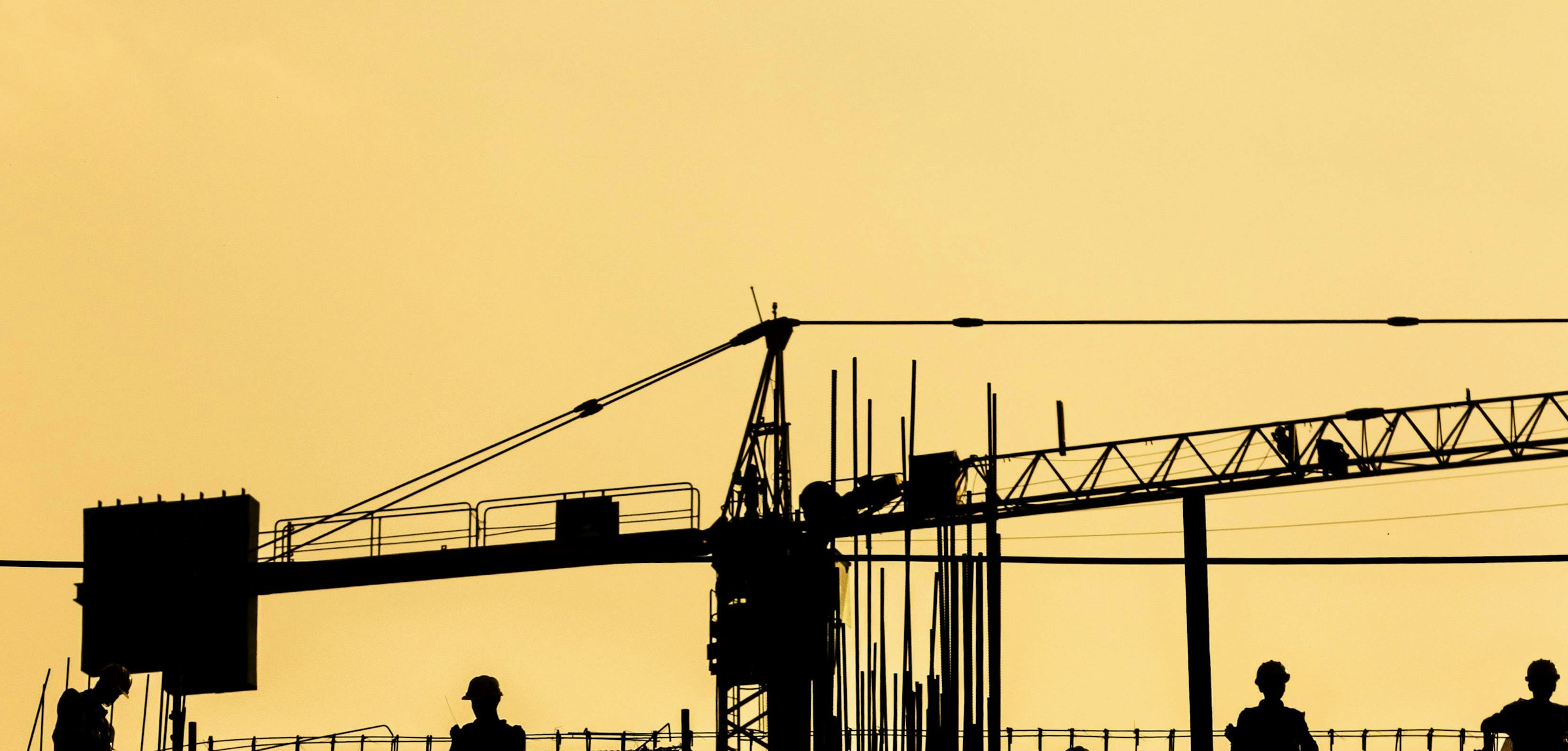 Tower cranes on a large-scale construction site in Saudi Arabia at golden hour